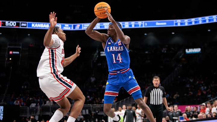 Mar 13, 2026; Kansas City, MO, USA; Kansas Jayhawks guard Melvin Council Jr. (14) drives to the basket around Houston Cougars guard Mercy Miller (25) during the second half at T-Mobile Center. Mandatory Credit: William Purnell-Imagn Images