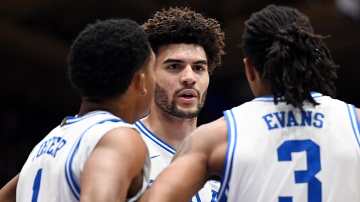 Feb 14, 2026; Durham, North Carolina, USA; Duke Blue Devils forward Cameron Boozer (12) huddles with teammates Caleb Foster (1) and Isaiah Evans (3) against the Clemson Tigers.