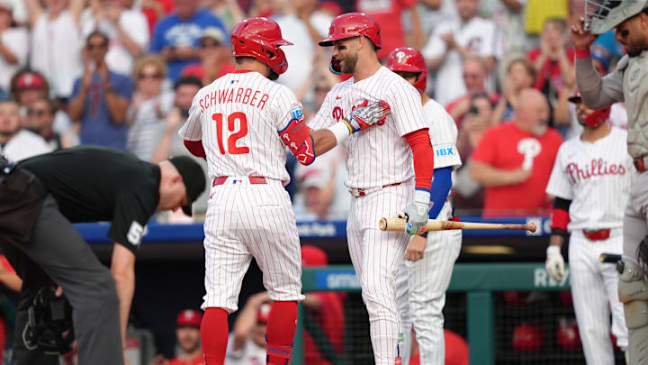 Philadelphia Phillies designated hitter Kyle Schwarber reacts with Bryce Harper against the Boston Red Sox during MLB game Philadelphia Phillies designated hitter Kyle Schwarber reacts with Bryce Harper against the Boston Red Sox during MLB game