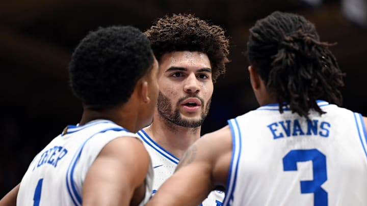 Feb 14, 2026; Durham, North Carolina, USA; Duke basketball forward Cameron Boozer (12) huddles with teammates Caleb Foster (1) and Isaiah Evans (3) during the first half against the Clemson Tigers at Cameron Indoor Stadium.