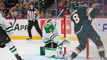 Sep 25, 2025; Saint Paul, Minnesota, USA; Dallas Stars goaltender Casey DeSmith (1) dives for a crossing pass to Minnesota Wild defenseman Zeev Buium (8) in the second period at Grand Casino Arena. Mandatory Credit: Matt Blewett-Imagn Images