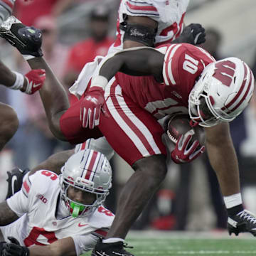 Oct 18, 2025; Madison, Wisconsin, USA;  Wisconsin running back Gideon Ituka (10) stumbles forward  during the fourth quarter of their game against Ohio State at Camp Randall Stadium. Mandatory Credit: Mark Hoffman-USA TODAY Network via Imagn Images