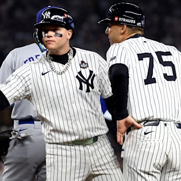 Oct 30, 2024; New York, New York, USA; New York Yankees outfielder Alex Verdugo (24) celebrates with first base coach Travis Chapman (75) after hitting a RBI single during the second inning against the Los Angeles Dodgers in game five of the 2024 MLB World Series at Yankee Stadium. 
