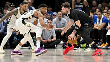 Feb 3, 2024; Dallas, Texas, USA; Dallas Mavericks guard Luka Doncic (77) looks to move the ball past Milwaukee Bucks guard Damian Lillard (0) and forward Giannis Antetokounmpo (34) during the second half at the American Airlines Center. Mandatory Credit: Jerome Miron-Imagn Images