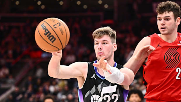 The Utah jazz center, Kyle Filipowski (22), passes the ball in front of the center of Portland Trail Blazers Donovan Clingan (23)