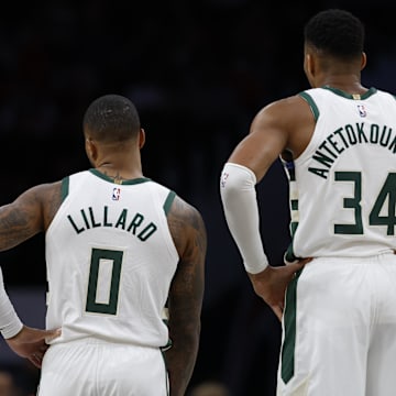 Milwaukee Bucks guard Damian Lillard (0) and Bucks forward Giannis Antetokounmpo (34) stand on the court against the Washington Wizards in the second quarter at Capital One Arena. 