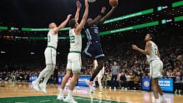 Nov 12, 2025; Boston, Massachusetts, USA; Memphis Grizzlies forward Olivier-Maxence Prosper (18) goes to the basket past Boston Celtics center Luka Garza (52) during the first quarter at TD Garden. Mandatory Credit: Winslow Townson-Imagn Images