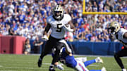 Sep 28, 2025; Orchard Park, New York, USA;  New Orleans Saints running back Kendre Miller (5) is tackled by Buffalo Bills cornerback Taron Johnson (7) during the fourth quarter at Highmark Stadium. Mandatory Credit: Gregory Fisher-Imagn Images