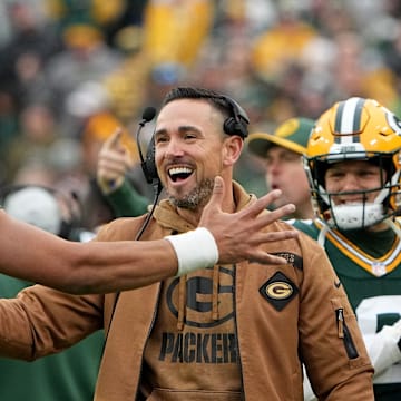 Green Bay Packers quarterback Jordan Love and coach Matt LaFleur celebrate a touchdown vs. the Rams last year.