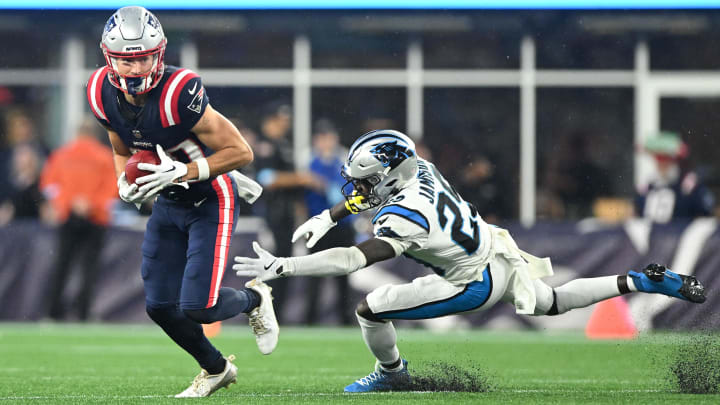 Aug 8, 2024; Foxborough, Massachusetts, USA; New England Patriots wide receiver David Wallis (30) returns the ball against Carolina Panthers cornerback D'Shawn Jamison (29) during the first half at Gillette Stadium. Mandatory Credit: Brian Fluharty-USA TODAY Sports