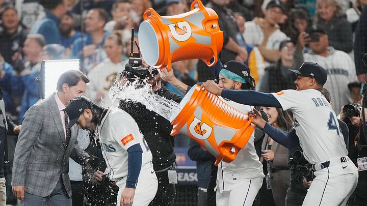 Oct 17, 2025; Seattle, Washington, USA; Seattle Mariners shortstop J.P. Crawford (3) and center fielder Julio Rodriguez (44) pour water on third baseman Eugenio Suarez (28) after game five of the ALCS round against the Toronto Blue Jays for the 2025 MLB playoffs at T-Mobile Park. Mandatory Credit: Stephen Brashear-Imagn Images