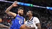 Dec 25, 2024; Dallas, Texas, USA; Dallas Mavericks forward Maxi Kleber (42) and Minnesota Timberwolves center Naz Reid (11) in action during the game between the Dallas Mavericks and the Minnesota Timberwolves at the American Airlines Center. Mandatory Credit: Jerome Miron-Imagn Images