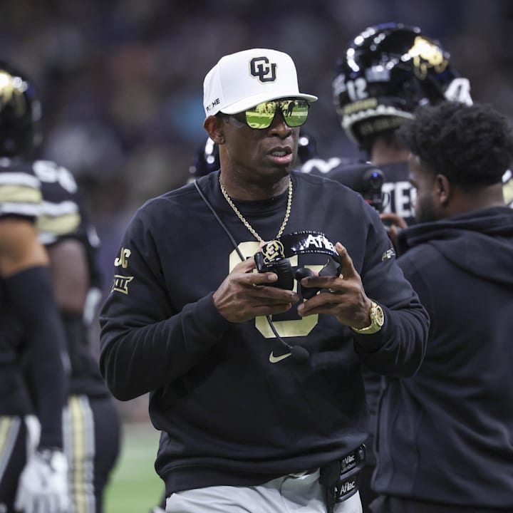 Colorado Buffaloes head coach Deion Sanders walks on the field between plays against the Brigham Young Cougars 