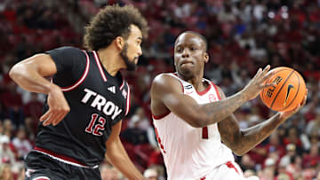 Nov 13, 2024; Fayetteville, Arkansas, USA; Arkansas Razorbacks guard Johnell Davis (1) drives against Troy Trojans guard Tayton Conway (12) during the second half at Bud Walton Arena. Arkansas won 65-49. Mandatory Credit: Nelson Chenault-Imagn Images