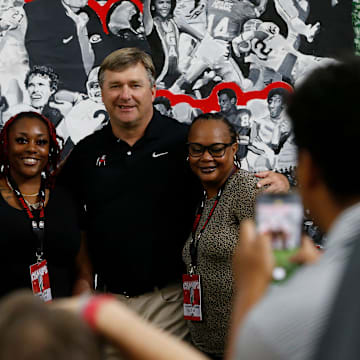 Kirby and Mary Beth Smart pose for photos with fans and supporters during the Kirby Smart Family Foundation's Giving Day at the UGA Football Indoor Practice Facility in Athens, Ga., on Wednesday, Aug. 10, 2022. The Kirby Smart Family Foundation supports over 70 organizations in Georgia and neighboring states that help children and families who are facing adversity such as disability and childhood cancer.

News Joshua L Jones