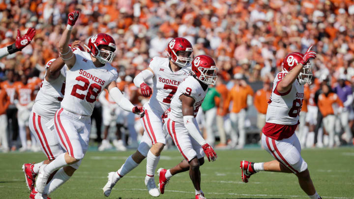 Oklahoma Sooners defensive back Gentry Williams (9) celebrates with Oklahoma Sooners linebacker Danny Stutsman (28), Oklahoma Sooners linebacker Jaren Kanak (7), and Oklahoma Sooners defensive lineman Rondell Bothroyd (80) after Williams intercepted a pass during the Red River Rivalry college football game between the University of Oklahoma Sooners (OU) and the University of Texas (UT) Longhorns at the Cotton Bowl in Dallas, Saturday, Oct. 7, 2023.