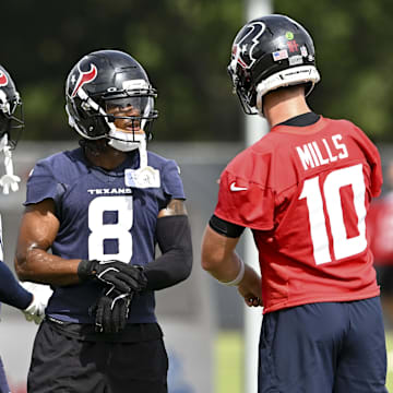 Jun 10, 2025; Houston, TX, USA; Houston Texans wide receiver John Metchie III (8) speaks with quarterback Davis Mills (10) during an NFL football minicamp at NRG Stadium. Mandatory Credit: Maria Lysaker-Imagn Images 