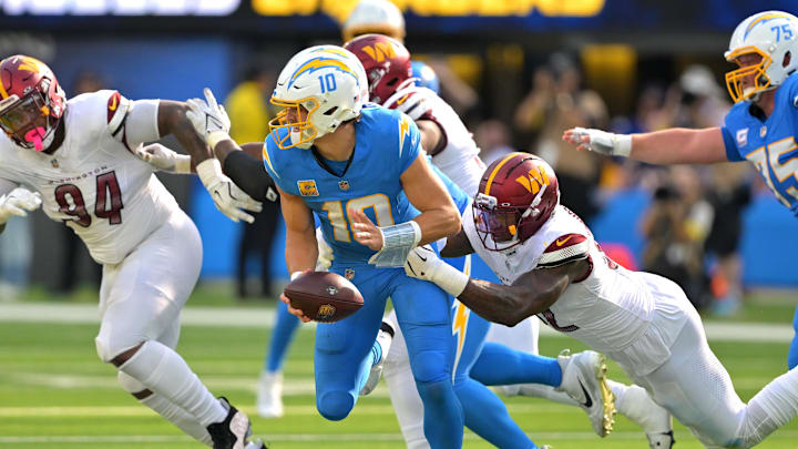 Oct 5, 2025; Inglewood, California, USA; Washington Commanders defensive end Dorance Armstrong (92) sacks Los Angeles Chargers quarterback Justin Herbert (10) in the second half at SoFi Stadium. Mandatory Credit: Jayne Kamin-Oncea-Imagn Images