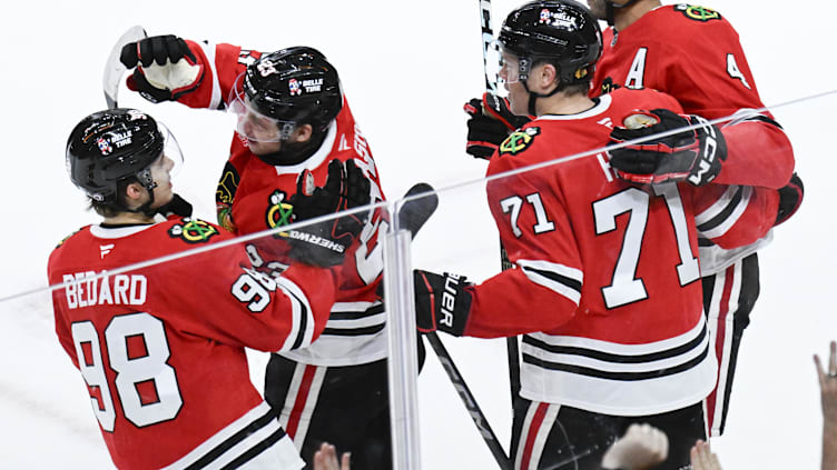 Nov 10, 2024; Chicago, Illinois, USA;  Chicago Blackhawks center Philipp Kurashev (23) celebrates with center Connor Bedard (98),  defenseman Seth Jones (4) and  left wing Taylor Hall (71)  after he scored the game winning goal against the Minnesota Wild during the overtime  period at the United Center. Mandatory Credit: Matt Marton-Imagn Images