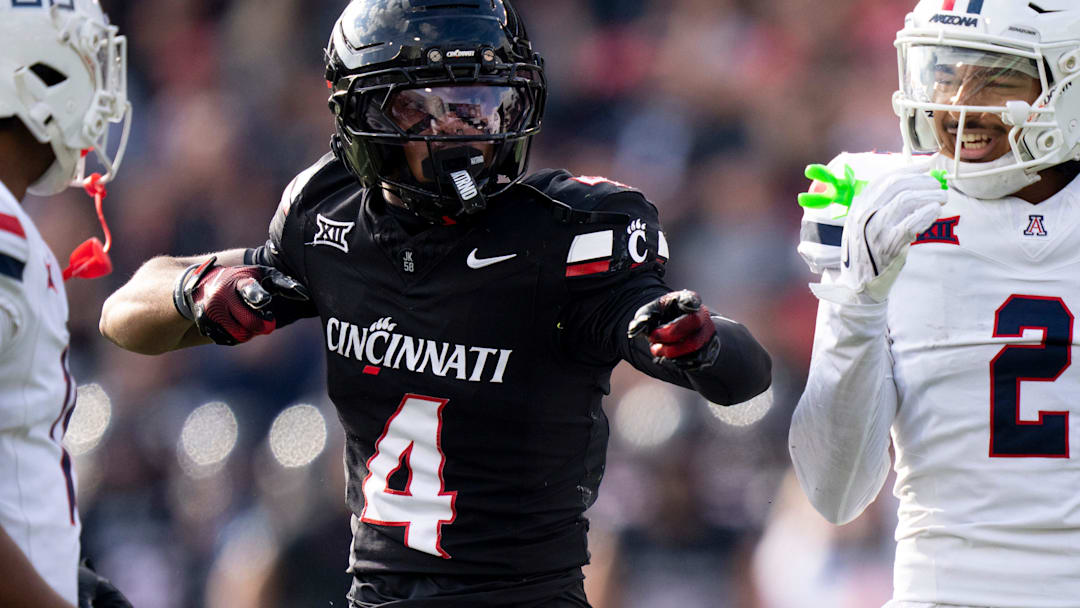 Cincinnati Bearcats wide receiver Cyrus Allen (4) gestures for a first down as Arizona Wildcats linebacker Jabari Mann (11) and Arizona Wildcats defensive back Treydan Stukes (2) react in the third quarter of the NCAA football game at Nippert Stadium in Cincinnati on Nov. 15, 2025.