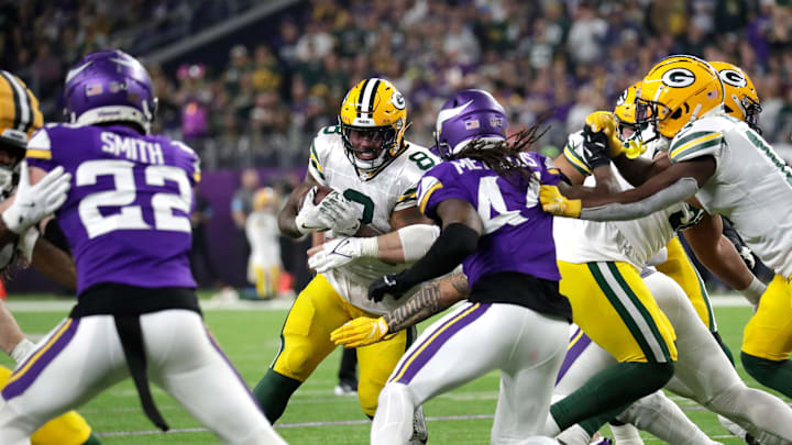 Green Bay Packers running back Josh Jacobs (8) looks for room to run against Minnesota Vikings safety Josh Metellus (44) during their football game Sunday, December 29, 2024, at U.S. Bank Stadium in Minneapolis, Minnesota. Green Bay Packers running back Josh Jacobs (8) looks for room to run against Minnesota Vikings safety Josh Metellus (44) during their football game Sunday, December 29, 2024, at U.S. Bank Stadium in Minneapolis, Minnesota.