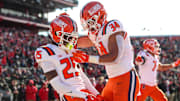 Nov 23, 2024; Piscataway, New Jersey, USA; Illinois Fighting Illini defensive back Jaheim Clarke (25) celebrates a defensive stop with linebacker Ryan Meed (34) during the first half against the Rutgers Scarlet Knights at SHI Stadium. Mandatory Credit: Vincent Carchietta-Imagn Images