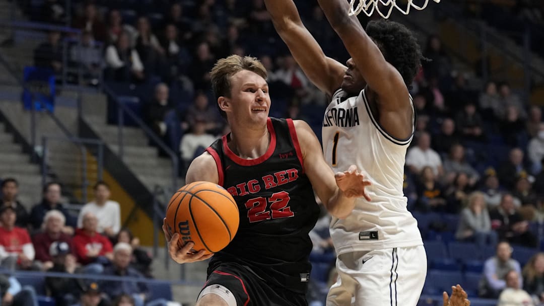 December 10, 2024; Berkeley, California, USA; Cornell Big Red guard Jake Fiegen (22) passes the basketball against California Golden Bears forward Joshua Ola-Joseph (1) during the second half at Haas Pavilion. Mandatory Credit: Kyle Terada-Imagn Images