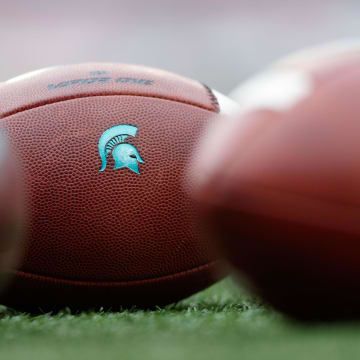 Oct 12, 2019; Madison, WI, USA; Michigan State Spartans logo on footballs during warmups prior to the game against the Wisconsin Badgers at Camp Randall Stadium. Mandatory Credit: Jeff Hanisch-USA TODAY Sports