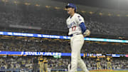 Jun 19, 2025; Los Angeles, California, USA;   Los Angeles Dodgers designated hitter Shohei Ohtani (17) laughs the San Diego Padres dugout while at first base after he was hit by a pitch in the ninth inning at Dodger Stadium. Mandatory Credit: Jayne Kamin-Oncea-Imagn Images
