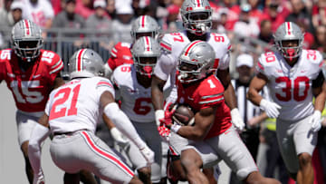 April 13, 2024; Columbus, Ohio, USA; 
Ohio State Buckeyes running back Quinshon Judkins (1) runs the football for the scarlet team while pursued by safety Jayden Bonsu (21) of the grey team during the first half of the LifeSports spring football game at Ohio Stadium on Saturday.
