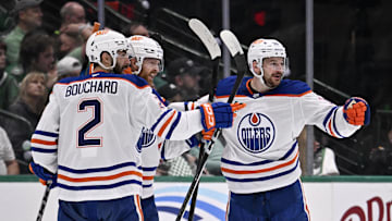 Edmonton Oilers defenseman Brett Kulak (27) and defenseman Evan Bouchard (2) and left wing Zach Hyman (18)