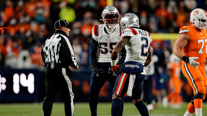 Dec 24, 2023; Denver, Colorado, USA; New England Patriots linebacker Josh Uche (55) reacts with cornerback Jalen Mills (2) after a play in the third quarter against the Denver Broncos at Empower Field at Mile High. Mandatory Credit: Isaiah J. Downing-Imagn Images