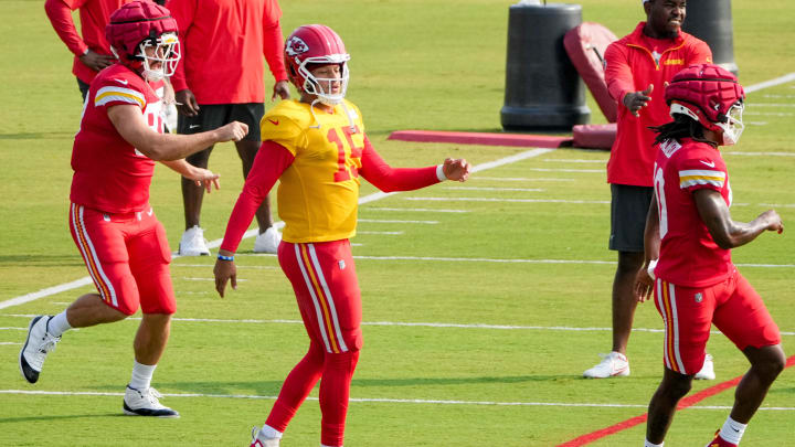 Jul 26, 2024; Kansas City, MO, USA; Kansas City Chiefs tight end Travis Kelce (87) and quarterback Patrick Mahomes (15) and running back Isiah Pacheco (10) stretch on field during training camp at Missouri Western State University. Mandatory Credit: Denny Medley-USA TODAY Sports