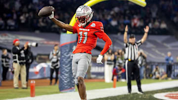 Dec 26, 2023; Phoenix, AZ, USA; UNLV Rebels wide receiver Ricky White (11) celebrates after scoring a touchdown against the Kansas Jayhawks in the Guaranteed Rate Bowl at Chase Field. Mandatory Credit: Mark J. Rebilas-USA TODAY Sports