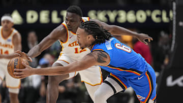 Oct 25, 2025; Atlanta, Georgia, USA; Atlanta Hawks center N'Faly Dante (12) and Oklahoma City Thunder forward Jaylin Williams (6) battle to control a loose ball during the first half at State Farm Arena. Mandatory Credit: Dale Zanine-Imagn Images