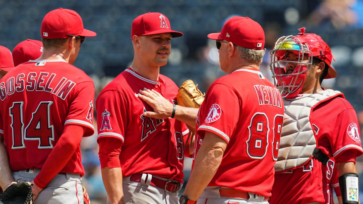 Jul 27, 2022; Kansas City, Missouri, USA; Los Angeles Angels starting pitcher Janson Junk (66) talks with interim manager Phil Nevin (88) during the sixth inning against the Kansas City Royals at Kauffman Stadium. Mandatory Credit: Jay Biggerstaff-USA TODAY Sports