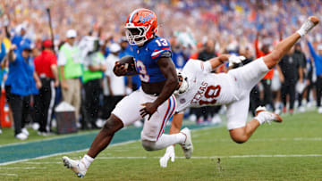 Oct 4, 2025; Gainesville, Florida, USA; Florida Gators running back Jadan Baugh (13) breaks a tackle from Texas Longhorns linebacker Liona Lefau (18) for a touchdown during the first half at Ben Hill Griffin Stadium. Mandatory Credit: Matt Pendleton-Imagn Images