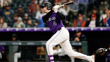 May 19, 2025; Denver, Colorado, USA; Colorado Rockies first baseman Michael Toglia (4) hits a double in the sixth inning against the Philadelphia Phillies at Coors Field. Mandatory Credit: Isaiah J. Downing-Imagn Images