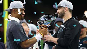 Philadelphia Eagles quarterback Jalen Hurts (1) passes the Vince Lombardi Trophy to Philadelphia Eagles head coach Nick Sirianni after defeating the Kansas City Chiefs in Super Bowl LIX at Ceasars Superdome.
