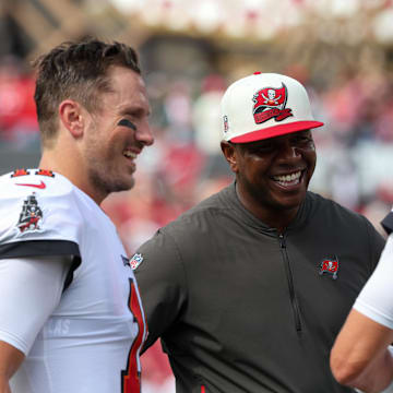 Sep 25, 2022; Tampa, Florida, USA;  Tampa Bay Buccaneers quarterback Tom Brady (12) quarterback Blaine Gabbert (11) and offensive coordinator Byron Leftwich talk before a game against the Green Bay Packers at Raymond James Stadium. Mandatory Credit: Nathan Ray Seebeck-Imagn Images