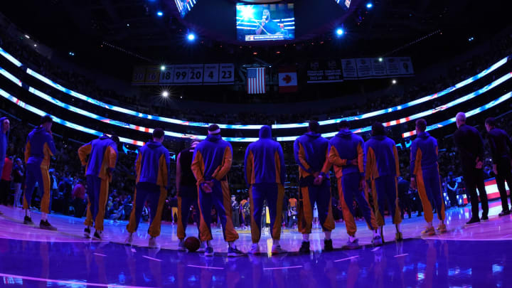 Apr 9, 2024; Los Angeles, California, USA; Golden State Warriors players observe the playing of the national anthem before the game against the Los Angeles Lakers at Crypto.com Arena. Mandatory Credit: Kirby Lee-USA TODAY Sports