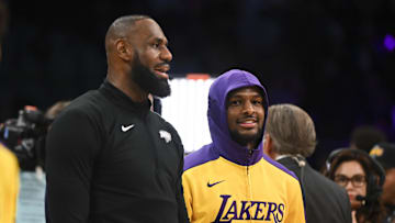 Oct 25, 2024; Los Angeles, California, USA; Los Angeles Lakers guard Bronny James (9) and forward LeBron James (23) warming up before the game against the Phoenix Suns at Crypto.com Arena. Mandatory Credit: Jonathan Hui-Imagn Images