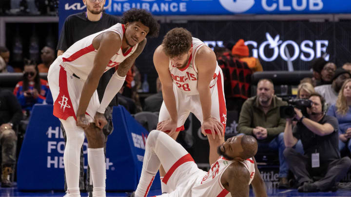 Jan 12, 2024; Detroit, Michigan, USA; Houston Rockets guard Jalen Green (4) and center Alperen Sengun (28) check on injured teammate forward Jeff Green (32) during the second half of the game against the Detroit Pistons at Little Caesars Arena. Mandatory Credit: David Reginek-USA TODAY Sports