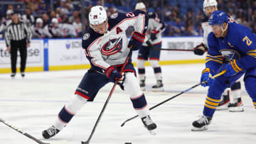 Sep 30, 2023; Buffalo, New York, USA;  Buffalo Sabres right wing Kyle Okposo (21) watches as Columbus Blue Jackets right wing Patrik Laine (29) controls the puck during the third period at KeyBank Center. Mandatory Credit: Timothy T. Ludwig-USA TODAY Sports