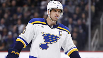 Apr 7, 2025; Winnipeg, Manitoba, CAN; St. Louis Blues center Brayden Schenn (10) looks on during a break in play against the Winnipeg Jets in the first period at Canada Life Centre. Mandatory Credit: James Carey Lauder-Imagn Images