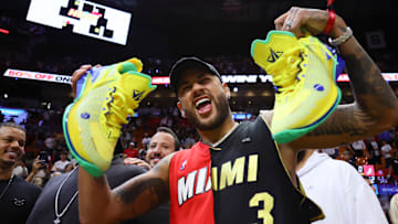 Mar 29, 2024; Miami, Florida, USA;  Brazilian professional soccer player Neymar Jr. reacts after receiving a pair of shoes from Miami Heat forward Jimmy Butler (not pictured) after the game against the Portland Trail Blazers at Kaseya Center. Mandatory Credit: Sam Navarro-Imagn Images