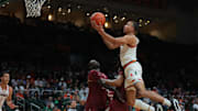 Jan 8, 2025; Coral Gables, Florida, USA; Miami Hurricanes guard Matthew Cleveland (0) drives to the basket against the Florida State Seminoles during the second half at Watsco Center. Mandatory Credit: Sam Navarro-Imagn Images