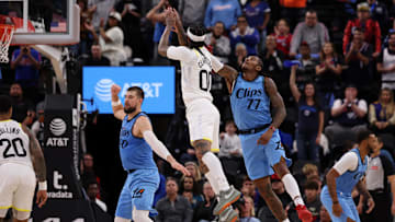 Nov 17, 2024; Inglewood, California, USA;  Utah Jazz guard Jordan Clarkson (00) shoots the ball against Los Angeles Clippers guard Kevin Porter Jr. (77) during the fourth quarter at Intuit Dome. Mandatory Credit: Kiyoshi Mio-Imagn Images
