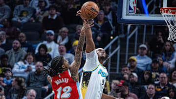 Feb 20, 2025; Indianapolis, Indiana, USA: Indiana Pacers center Myles Turner (33) blocks the shot of Memphis Grizzlies guard Ja Morant (12) in the second half at Gainbridge Fieldhouse. Mandatory Credit: Trevor Ruszkowski-Imagn Images
