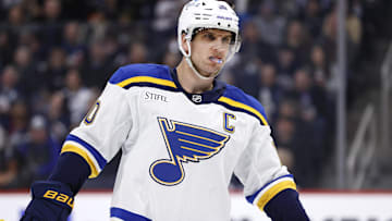 Apr 7, 2025; Winnipeg, Manitoba, CAN; St. Louis Blues center Brayden Schenn (10) looks on during a break in play against the Winnipeg Jets in the first period at Canada Life Centre. Mandatory Credit: James Carey Lauder-Imagn Images